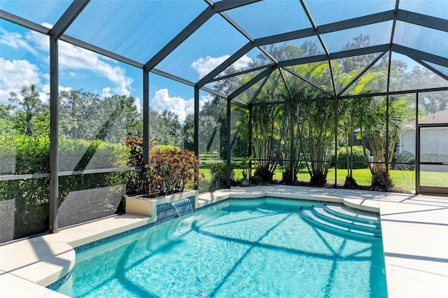 view of pool with a patio and a lanai