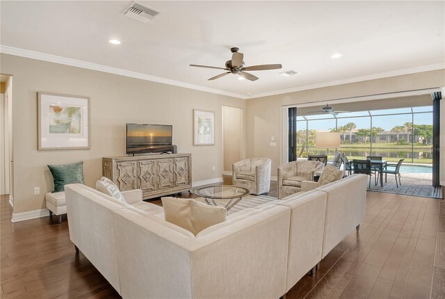 living room with ceiling fan, crown molding, and dark wood-type flooring