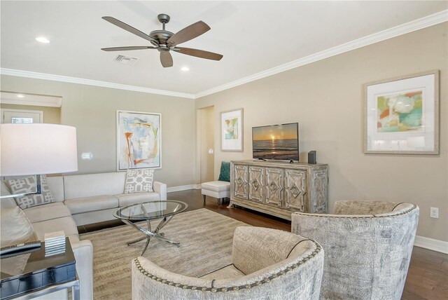 living room with crown molding, dark hardwood / wood-style floors, and ceiling fan