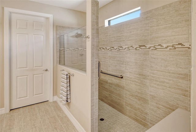 bathroom with a tile shower