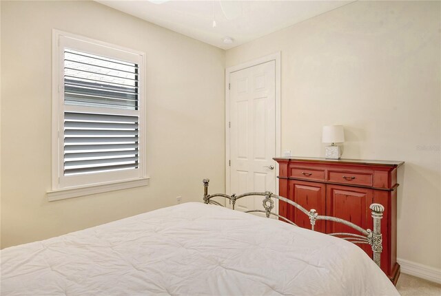 bedroom featuring ceiling fan and light colored carpet