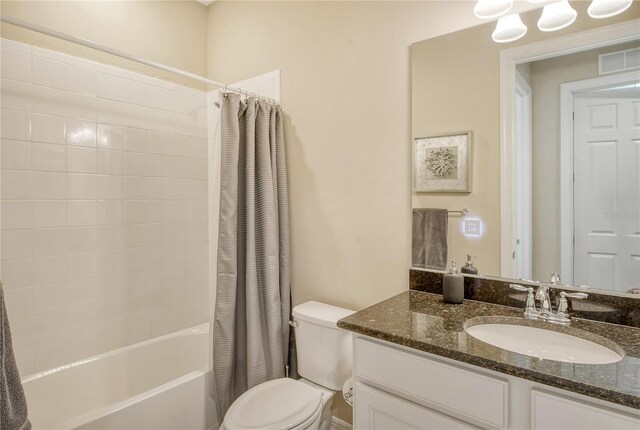 full bathroom with vanity, toilet, and shower / tub combo with curtain