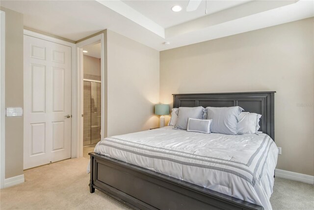 carpeted bedroom with ensuite bath