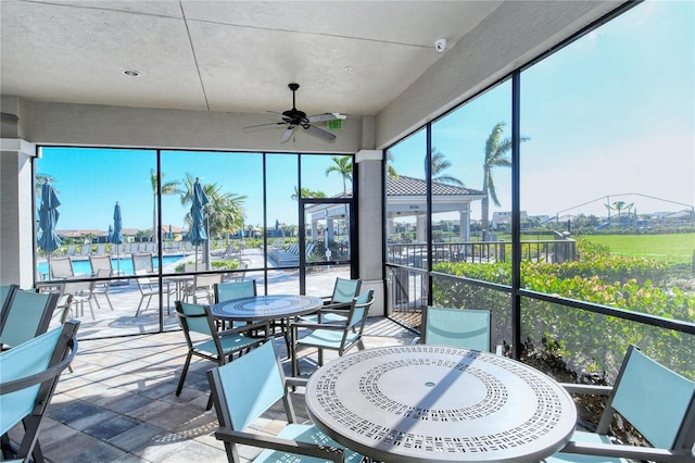 sunroom featuring ceiling fan