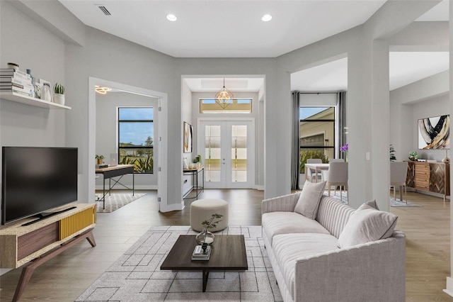 living room featuring light hardwood / wood-style flooring and a chandelier