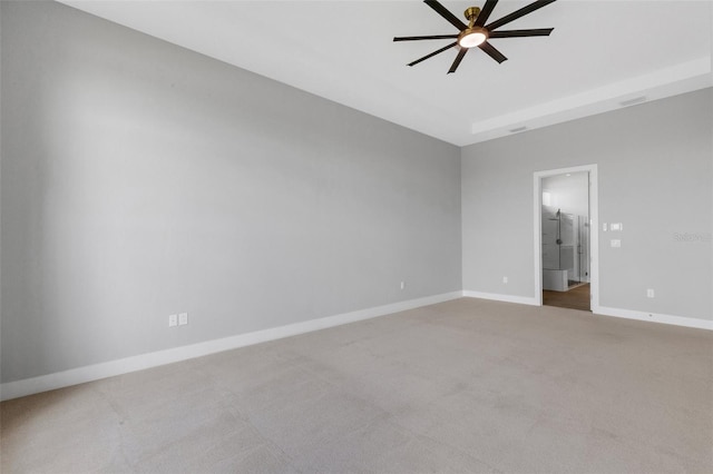 spare room with ceiling fan and carpet