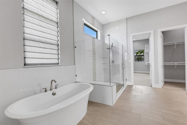 bathroom with shower with separate bathtub