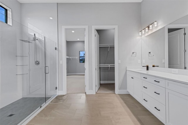 bathroom featuring an enclosed shower and vanity