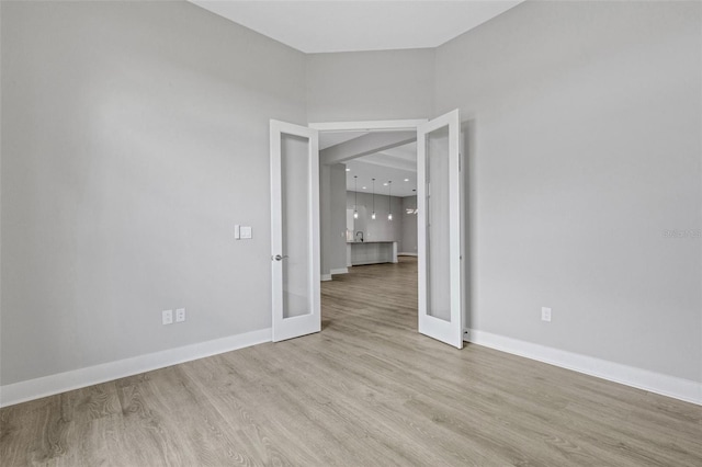 spare room with light hardwood / wood-style floors