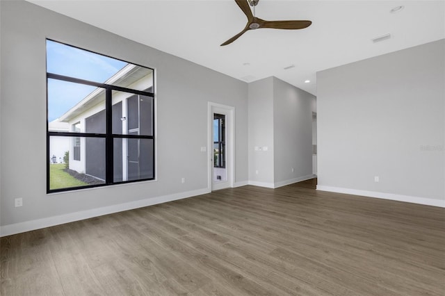 empty room featuring ceiling fan and hardwood / wood-style flooring