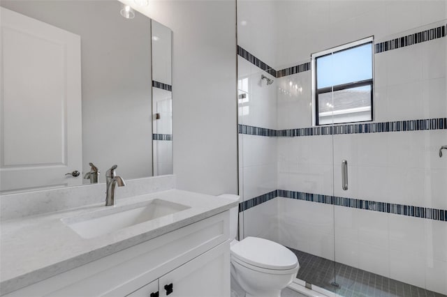 bathroom featuring vanity, toilet, and an enclosed shower