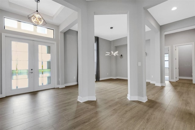 entryway featuring a healthy amount of sunlight, hardwood / wood-style floors, and french doors