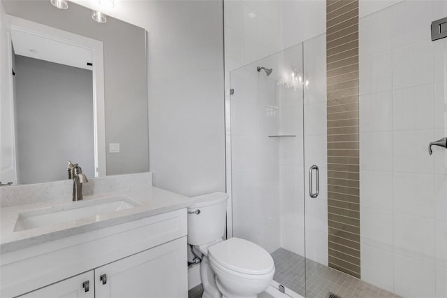 bathroom with walk in shower, vanity, and toilet