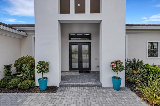 view of exterior entry featuring french doors