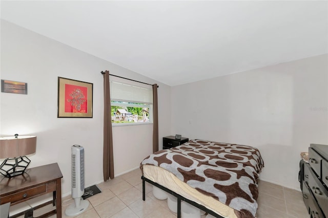 bedroom with vaulted ceiling and light tile patterned floors