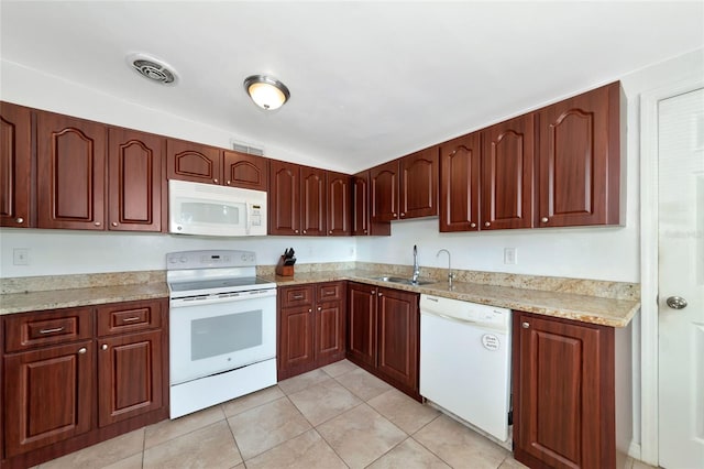 kitchen featuring white appliances, light tile patterned flooring, sink, and light stone counters