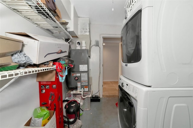 washroom with stacked washing maching and dryer