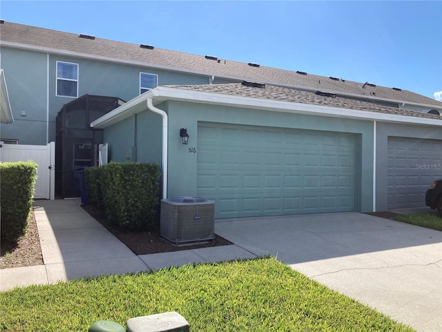 view of front of property with cooling unit and a garage