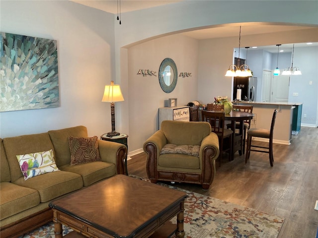 living room featuring an inviting chandelier and hardwood / wood-style floors