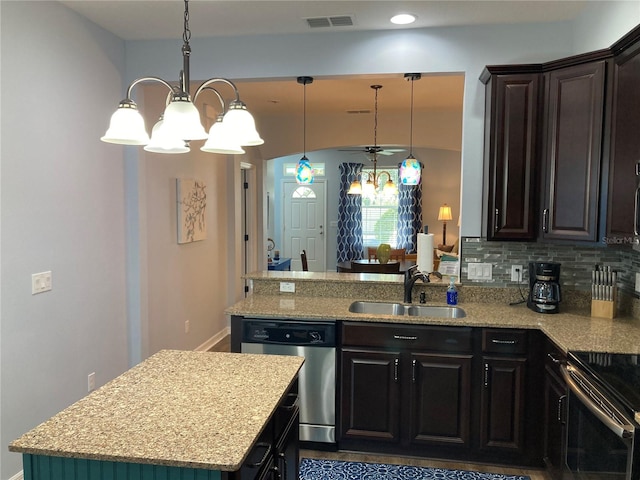 kitchen featuring tasteful backsplash, dishwasher, decorative light fixtures, sink, and a notable chandelier