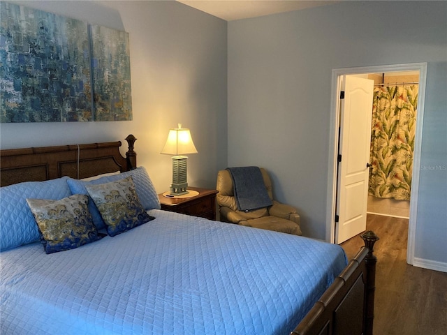 bedroom with dark wood-type flooring