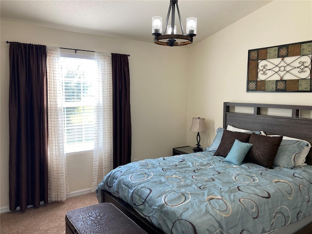 carpeted bedroom featuring a notable chandelier and lofted ceiling