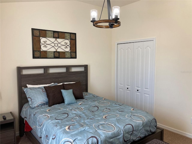 bedroom featuring an inviting chandelier, a closet, and carpet floors