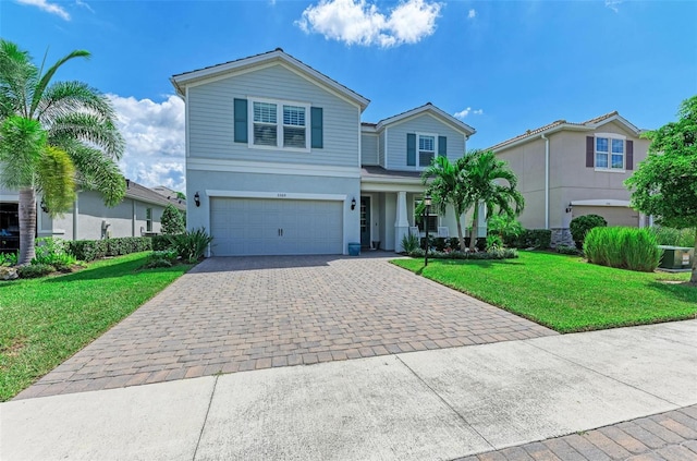 front of property featuring a garage, central AC unit, and a front lawn