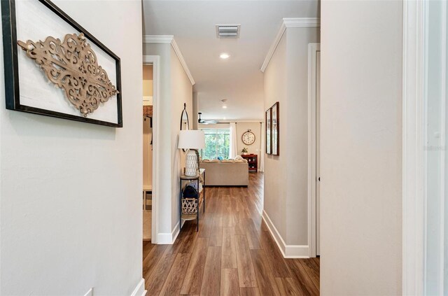 3360 Chestertown Loop, Bradenton, FL 34211 - hallway with ornamental molding, baseboards, visible vents, and wood finished floors