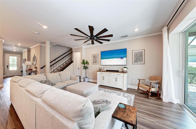 living room with crown molding, ceiling fan, and hardwood / wood-style flooring