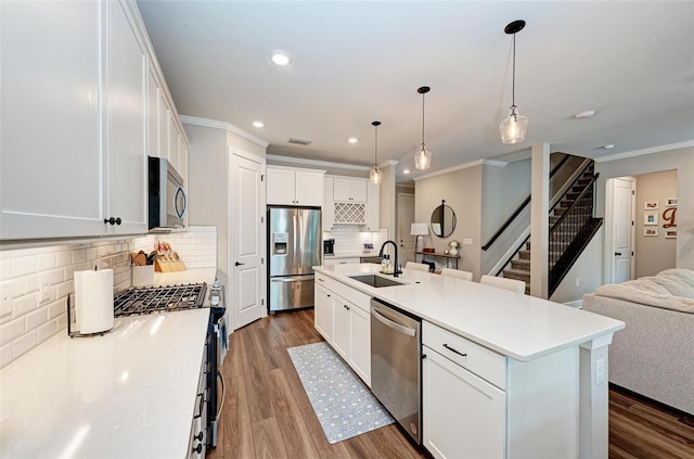 3360 Chestertown Loop, Bradenton, FL 34211 - kitchen with a sink, stainless steel appliances, open floor plan, crown molding, and recessed lighting