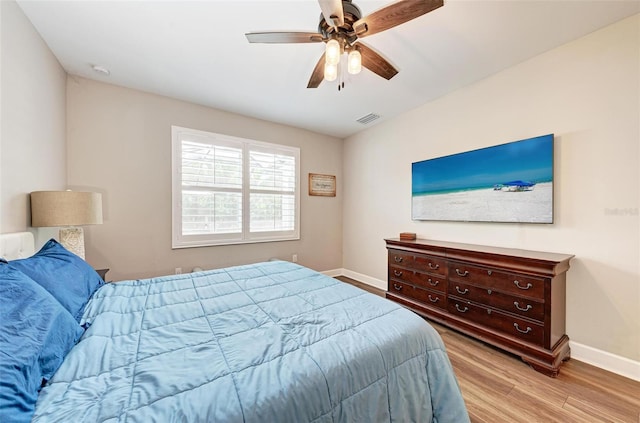 3360 Chestertown Loop, Bradenton, FL 34211 - bedroom featuring baseboards, a ceiling fan, visible vents, and wood finished floors