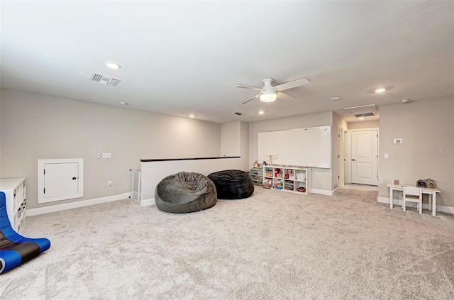 game room with ceiling fan and light colored carpet