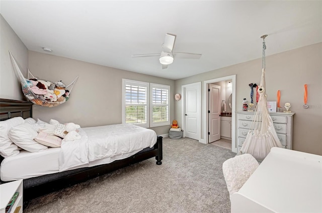 carpeted bedroom with ceiling fan and ensuite bathroom