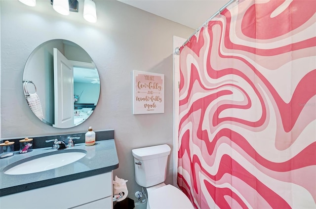 bathroom with walk in shower, vanity, and toilet