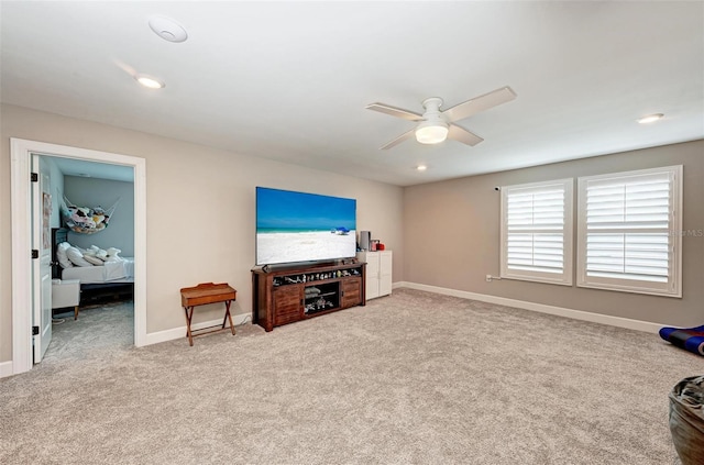 interior space with ceiling fan and light colored carpet