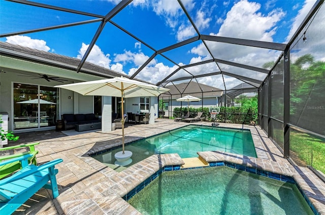 view of pool featuring outdoor lounge area, a lanai, an in ground hot tub, and a patio area