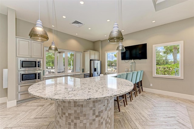 3360 Chestertown Loop, Bradenton, FL 34211 - kitchen with stainless steel appliances, recessed lighting, a warming drawer, light stone countertops, and baseboards