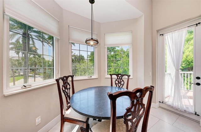 tiled dining space featuring a healthy amount of sunlight