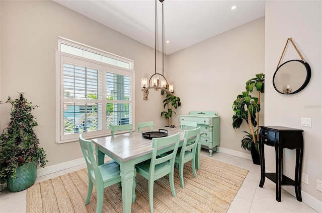 tiled dining area featuring a chandelier