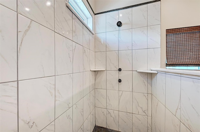 bathroom with a tile shower