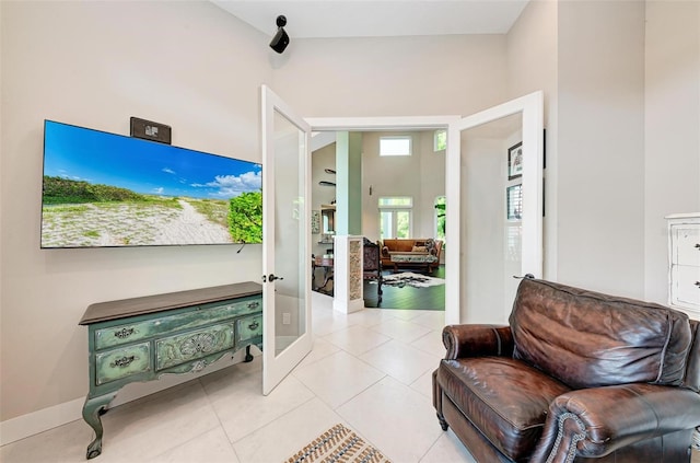 interior space with high vaulted ceiling and light tile patterned floors