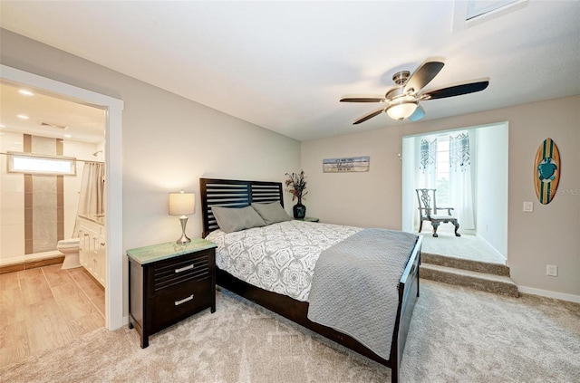 bedroom featuring ensuite bath, light wood-type flooring, and ceiling fan