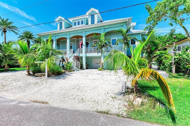 beach home featuring a porch and a garage