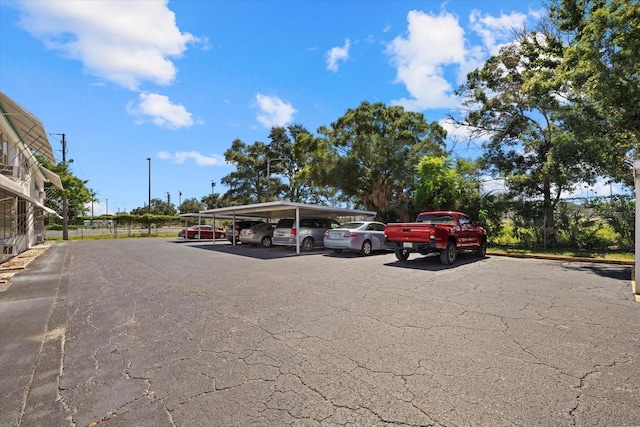 view of parking / parking lot featuring a carport