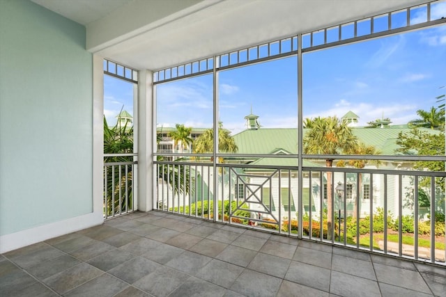 unfurnished sunroom featuring a water view