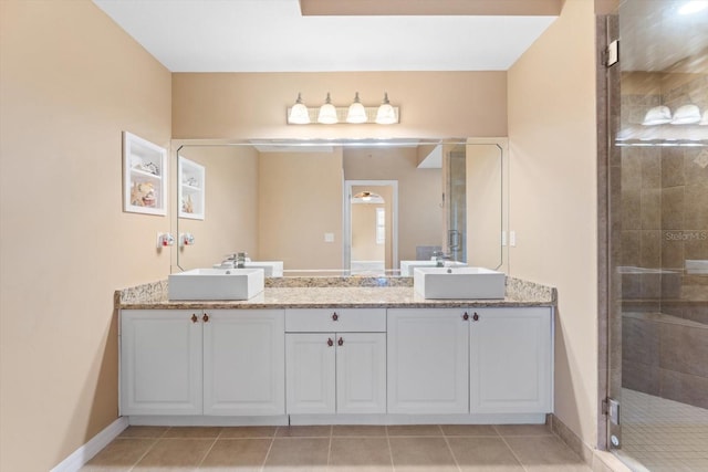 bathroom with walk in shower, tile patterned flooring, and vanity