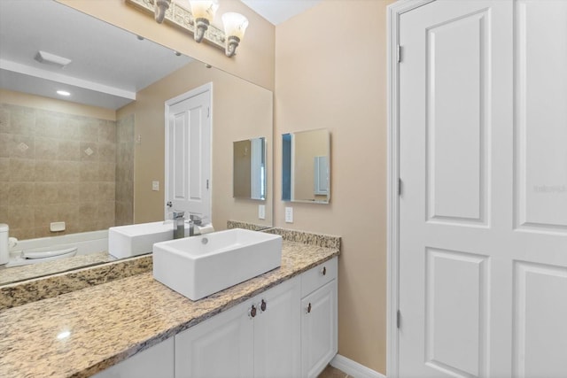 full bath with baseboards and vanity