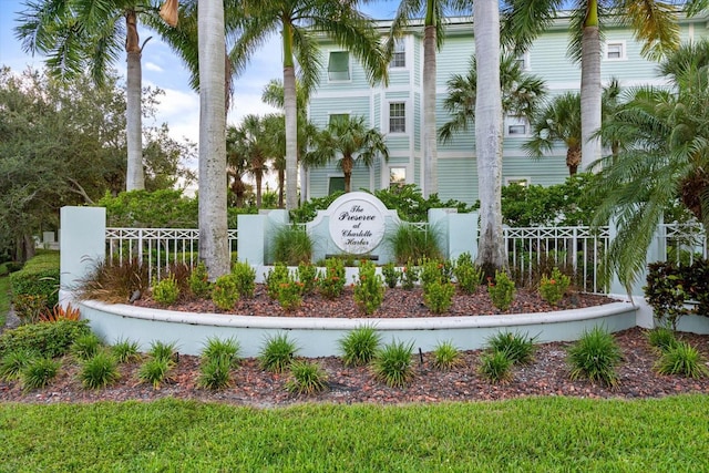 community sign featuring fence