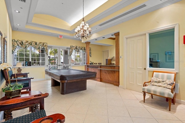 rec room with a tray ceiling, french doors, visible vents, ornamental molding, and ornate columns